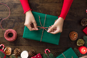 A person wrapping; Christmas gift ideas