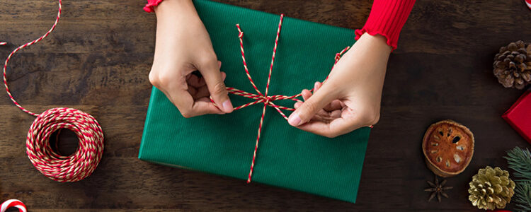 A person wrapping; Christmas gift ideas