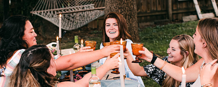 world market bend, friends toasting at outdoor dinner party