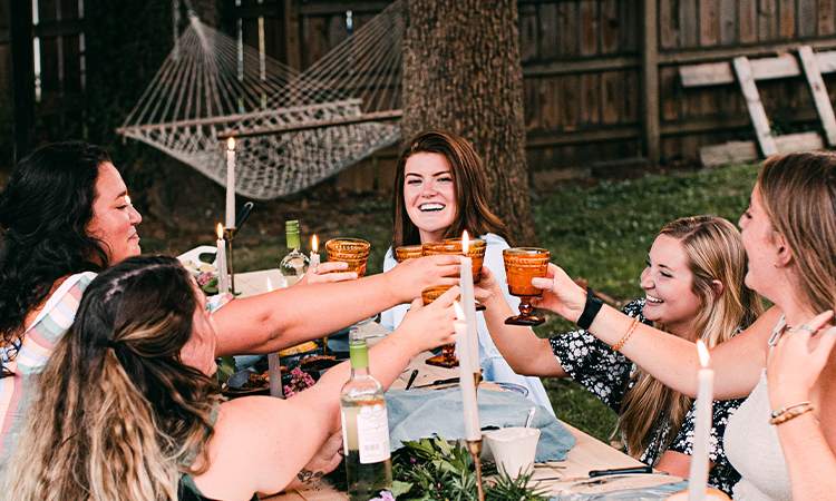 world market bend, friends toasting at outdoor dinner party