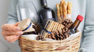A Valentine's Day gift basket containing wine, and various food items.