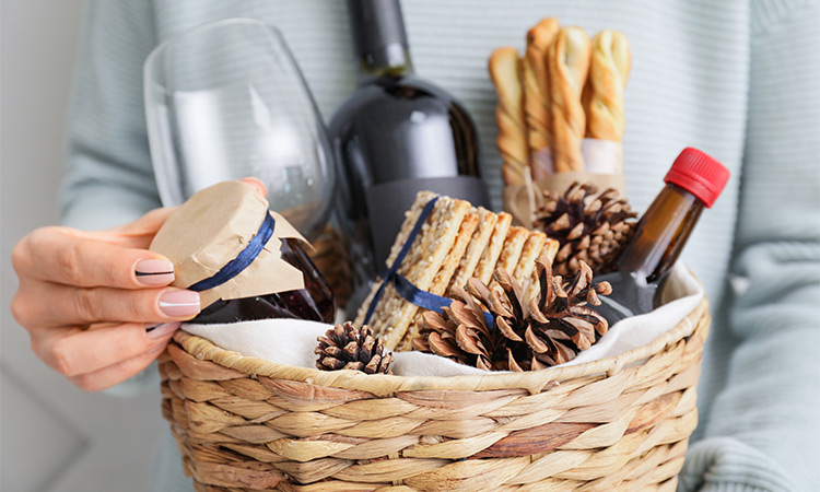 A Valentine's Day gift basket containing wine, and various food items.