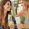 summer essentials, two ladies laughing with drinks in hand