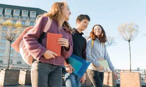 Kids walking outside at school showing off pieces from their capsule wardrobe
