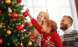 festive finds, family decorating a tree