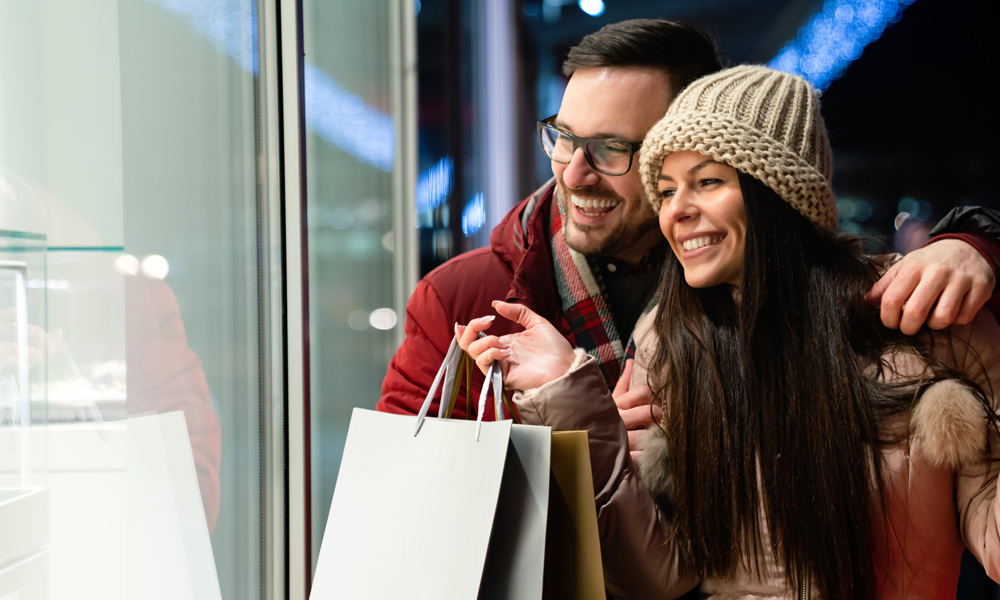 couple in winter clothes window shopping outside store for a blog about Self-Care Shopping at the CVSC