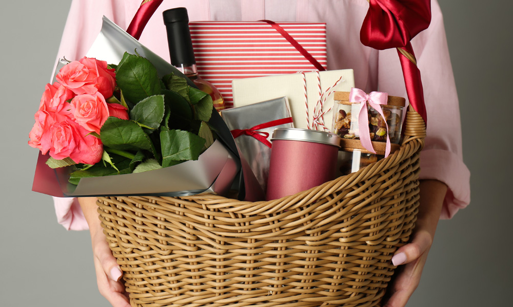 Woman holding gift basket for a blog about valentine's day gift basket ideas